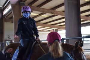 Sydney throwing her stress into the pasture and getting ready to ride